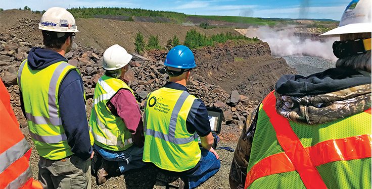 Team reviewing drilling and blasting safety at an open-cut mine