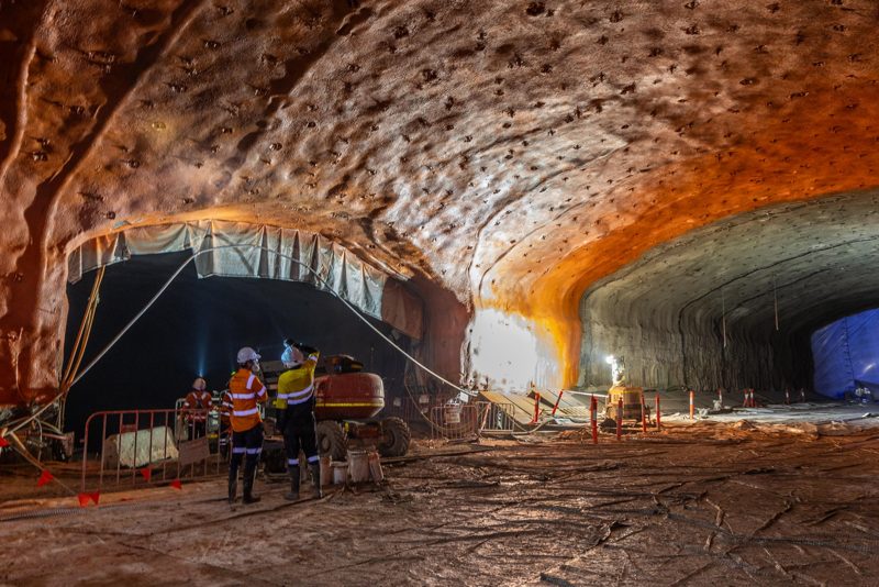 Crews working inside a large excavated cavern
