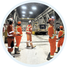 Operational team members walking through an underground work area