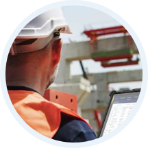 Supervisor in a hard hat reviewing site equipment