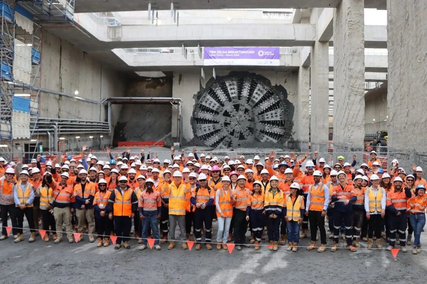 Project crew assembled in front of a tunnel boring machine cutterhead