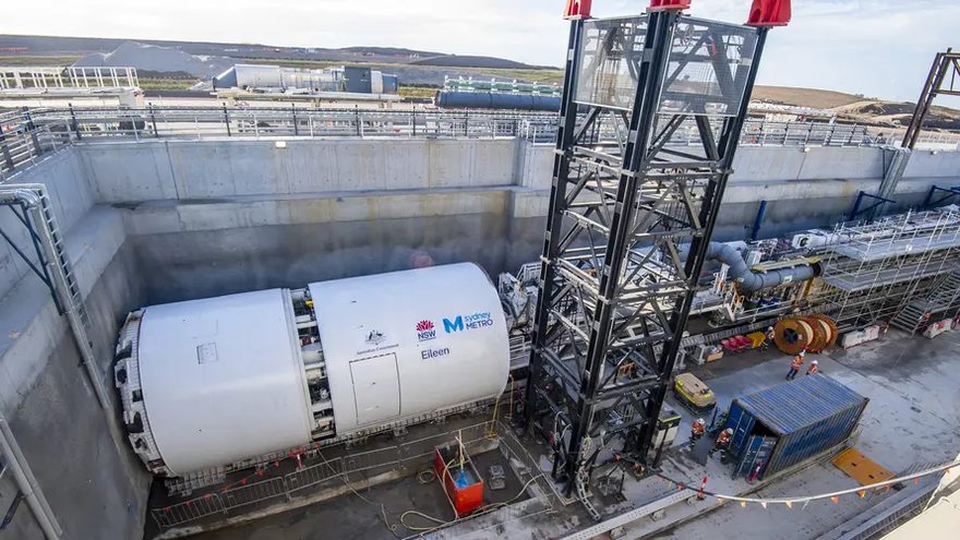 Tunnel boring machine shield at a launch shaft beside gantry cranes