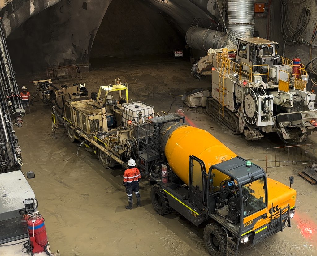 Agitator truck and roadheader working in an underground cavern