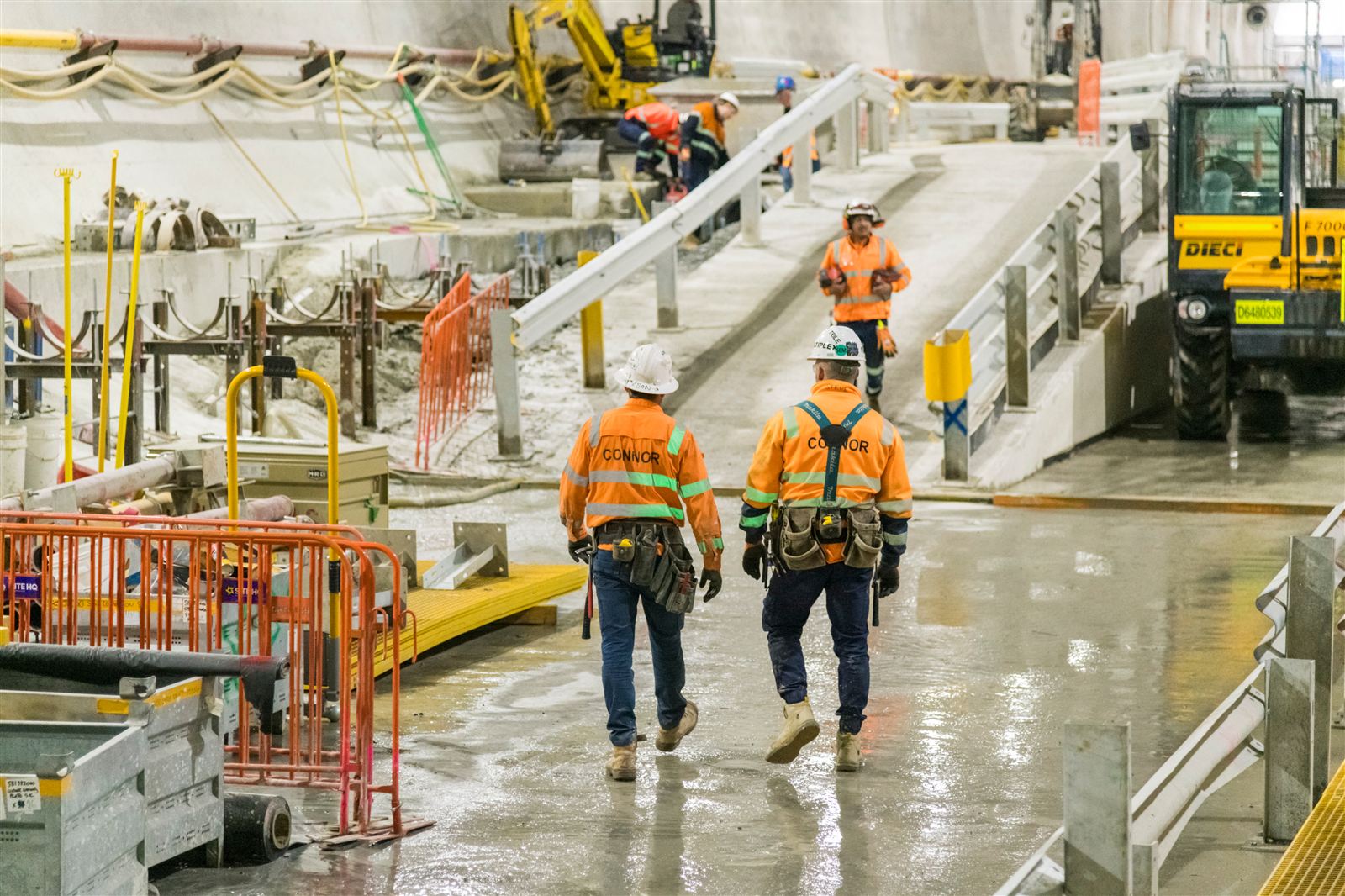 Workforce and vehicles operating across an underground construction site