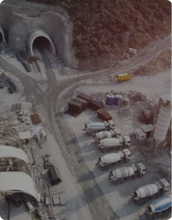 Aerial view of a tunnel portal and vehicle staging area on a large construction site