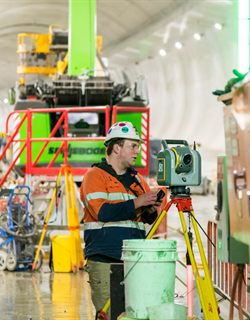 Surveyor operating a total station inside a tunnel