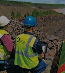 Workers surveying conditions across an open site