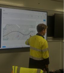 Operations team reviewing live site data on a control-room display